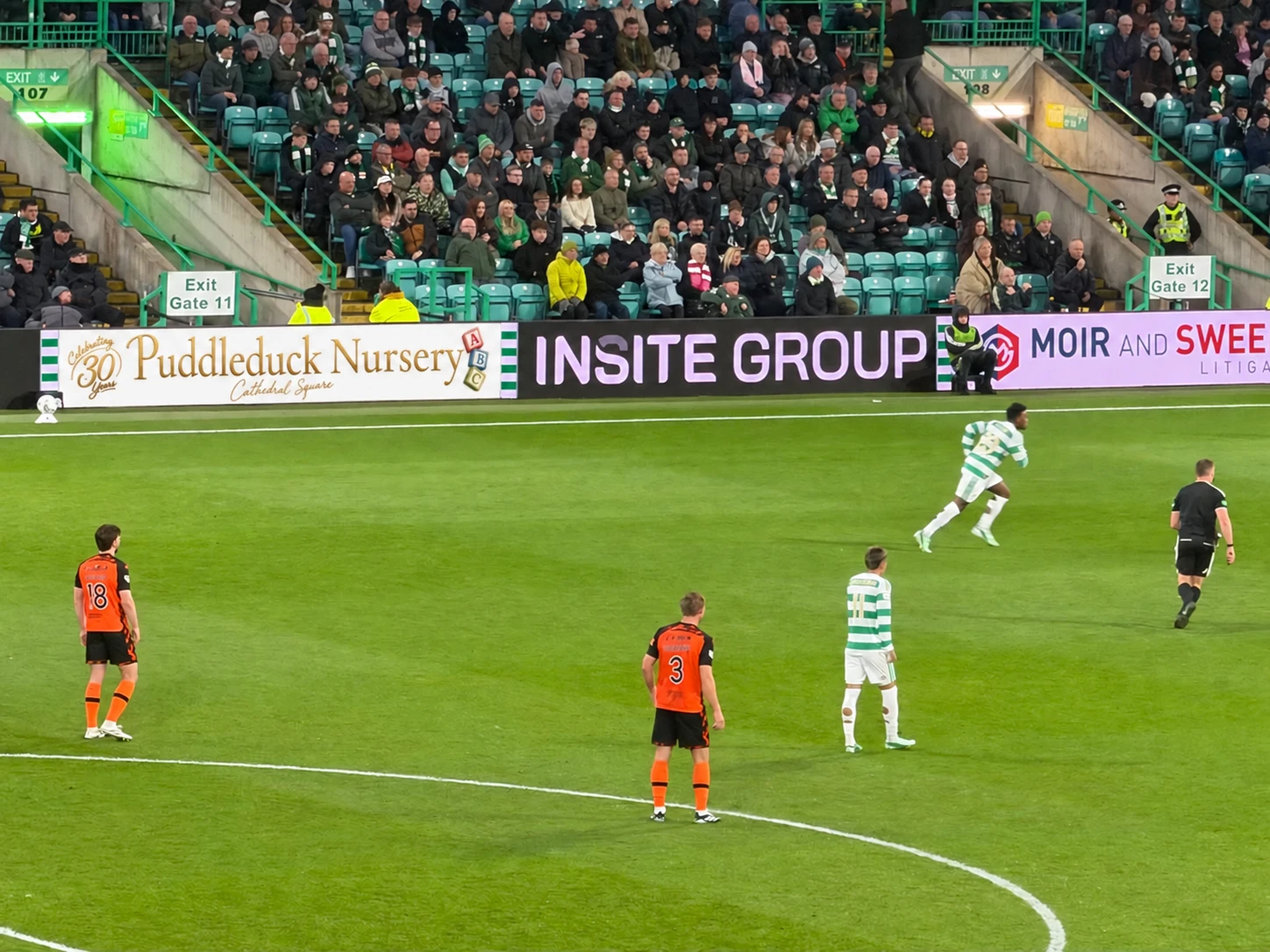 Puddleduck Nursery's 30th anniversary advertising board beside the pitch at Celtic Park.